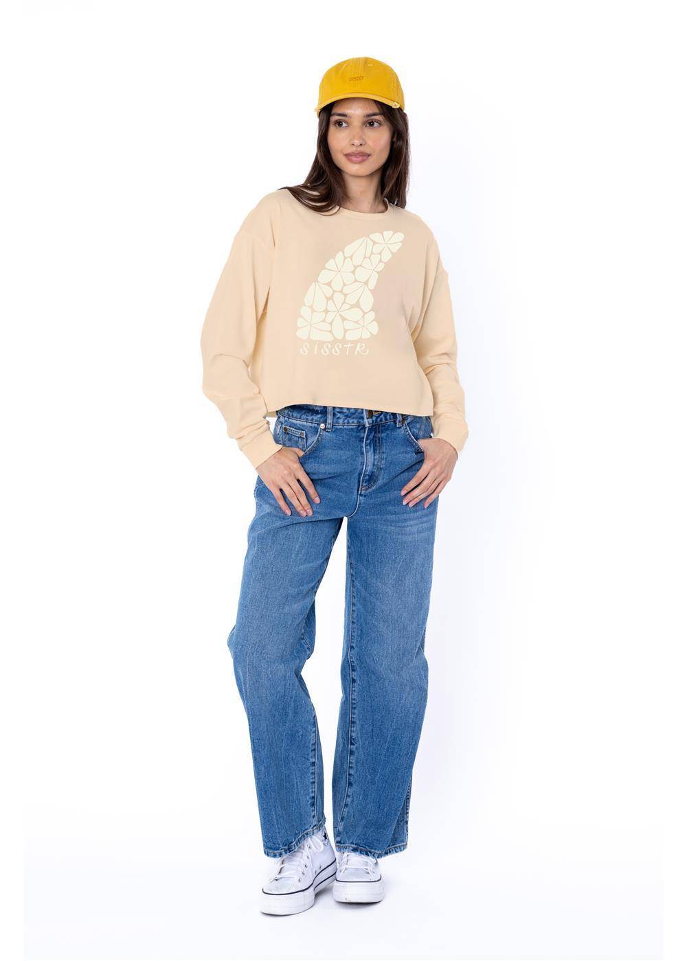 Sisstrevolution Floral Fin Crop LS Knit Tee in shell color, featuring a floral graphic on the front, styled with blue jeans.