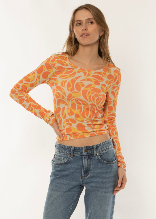 Sisstrevolution Skyscape LS Knit in coral with vibrant abstract print, front view.